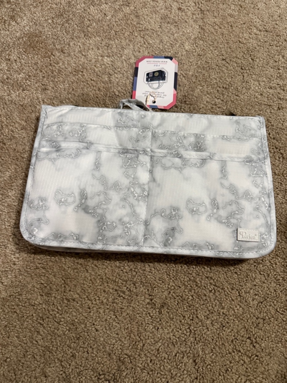 Periea handbag organizer insert designed to keep items tidy within a purse.